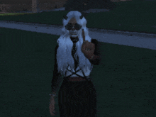 a woman with a skull on her face is giving the middle finger
