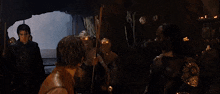a cave with a dragon in the water and a person standing in the water