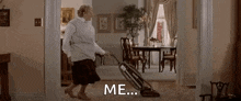 a woman is using a vacuum cleaner to clean the floor of a living room .