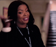 a woman wearing a lanyard that says ' johnson & johnson ' on it is smiling