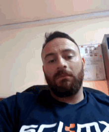 a man with a beard is wearing a shirt that says ' eclmx ' on it