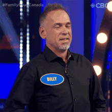 a man wearing a black shirt with a name tag that says billy