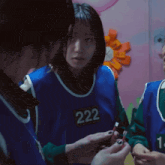 a girl wearing a blue vest with the number 1 on the front