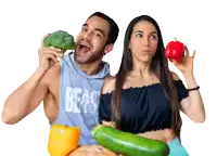 a man and a woman holding vegetables with the man wearing a hoodie that says beast