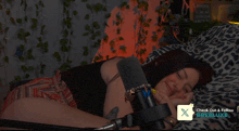 a woman laying on a bed giving a thumbs up sign