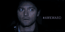 a close up of a man 's face with the word awkward written below him