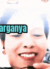 a close up of a woman 's face with the word arganya written above her