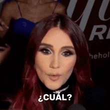a close up of a woman 's face with the word cual on it