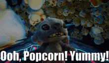 a picture of a stuffed animal with the words ooh popcorn yummy on the bottom