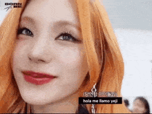 a close up of a woman 's face with orange hair and red lipstick .