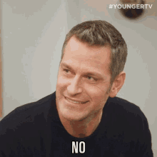 a man in a black shirt says " no "