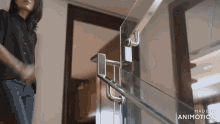 a woman in a black shirt is standing next to a glass railing made in animatica