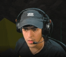 a man wearing a hat that says vans on it