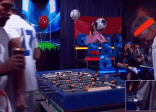 a group of people playing a game of foosball