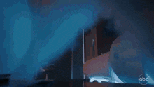 a group of people are dancing in a room with the abc logo on the bottom