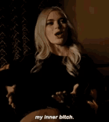 a woman is sitting on a couch talking to someone and says `` my inner bitch '' .