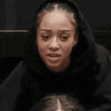 a woman is making a surprised face with her mouth wide open .