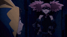 a girl with pink hair is wearing a black mask and earrings