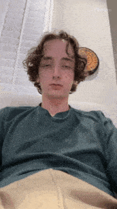 a young man is laying on a couch with his eyes closed and the word pollo ai visible in the corner