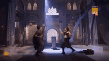 two people are dancing in a room with a sony sab logo on the bottom right