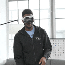 a man wearing a black hoodie that says wd black on it