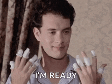 a man with a lot of bandages on his fingers is ready to go .