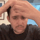 a man with a mustache is making a funny face