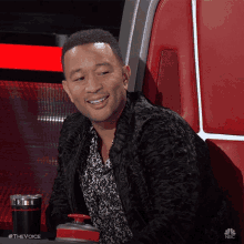 a man sitting in a chair with a nbc logo on the bottom right