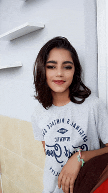 a girl wearing a gray t-shirt that says ' ytl ' on it