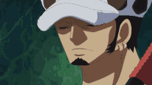a man with a beard wearing a white hat