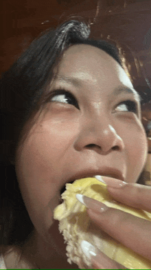 a woman with white nails is eating a piece of cake