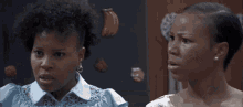two women are talking to each other in a kitchen .