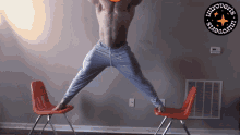 a shirtless man is jumping in the air between two red chairs with a logo for introverts on the bottom