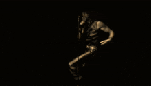 a man with dreadlocks singing into a microphone in a dark room