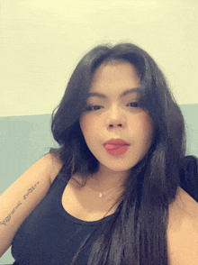 a woman has a tattoo on her arm that says ' i love you '