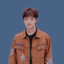 a man wearing a brown striped jacket with stars on the sleeves