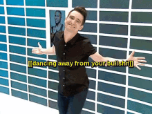 a man is dancing in front of a wall that says dancing away from your bullshit on it