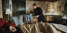 a man standing next to a woman laying on a bed with the hashtag rocktheholygrail visible in the corner