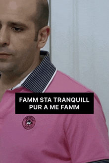 a man wearing a pink shirt with the words famm sta tranquil pur a me famm on the bottom