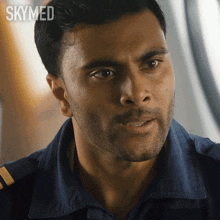 a close up of a man 's face with skymed written on the bottom