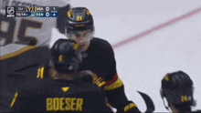 a hockey player wearing a jersey that says boeser