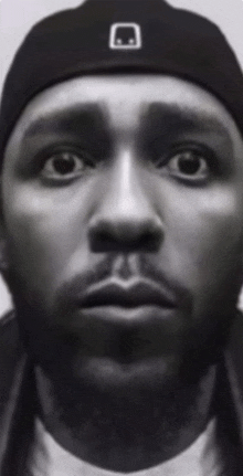 a close up of a man 's face wearing a hat
