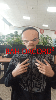 a man taking a picture of himself with bah dacord written on the bottom right