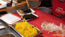 a person in a red apron is standing in front of a table with food on it and the words made in animatica on the bottom