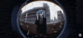 a girl in a suit and tie is looking through a doorbell