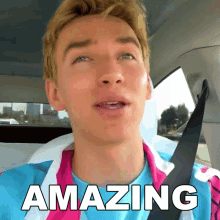 a man sitting in a car with the word amazing written on his face
