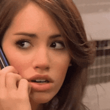a close up of a woman talking on her cell phone