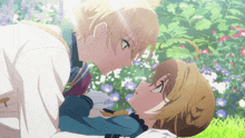 a boy and a girl are kissing in a garden with flowers in the background