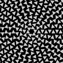 there are many white triangles on a black background .