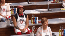 a man wearing a white apron that says rogelio on it
